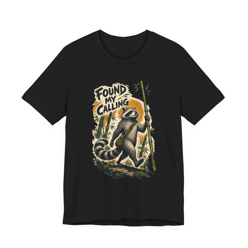 Zen raccoon t-shirt: a raccoon holding a bamboo stalk like a monk's staff, black unisex tee