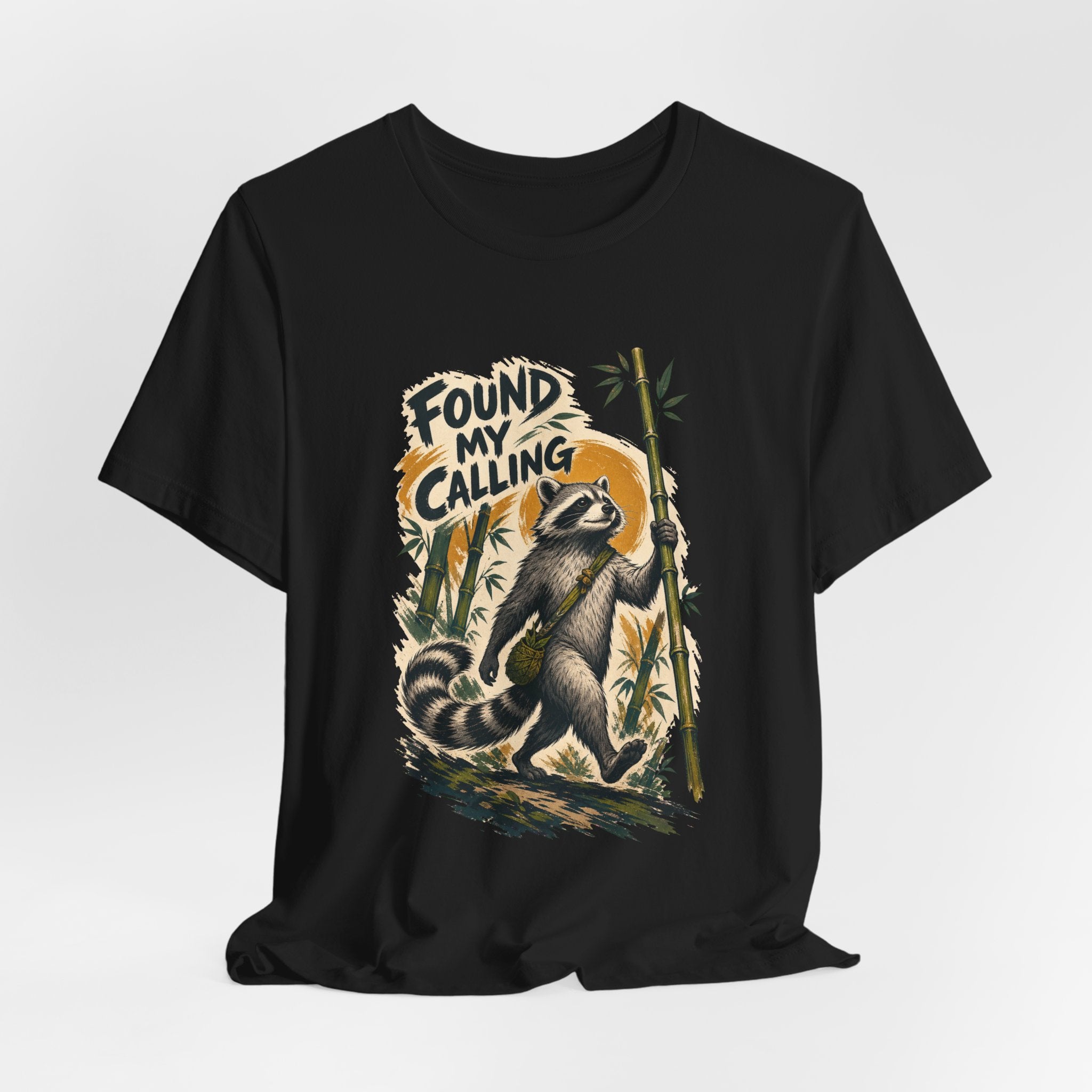 Zen raccoon monk design shown on a black unisex tee, Wrong Habitat